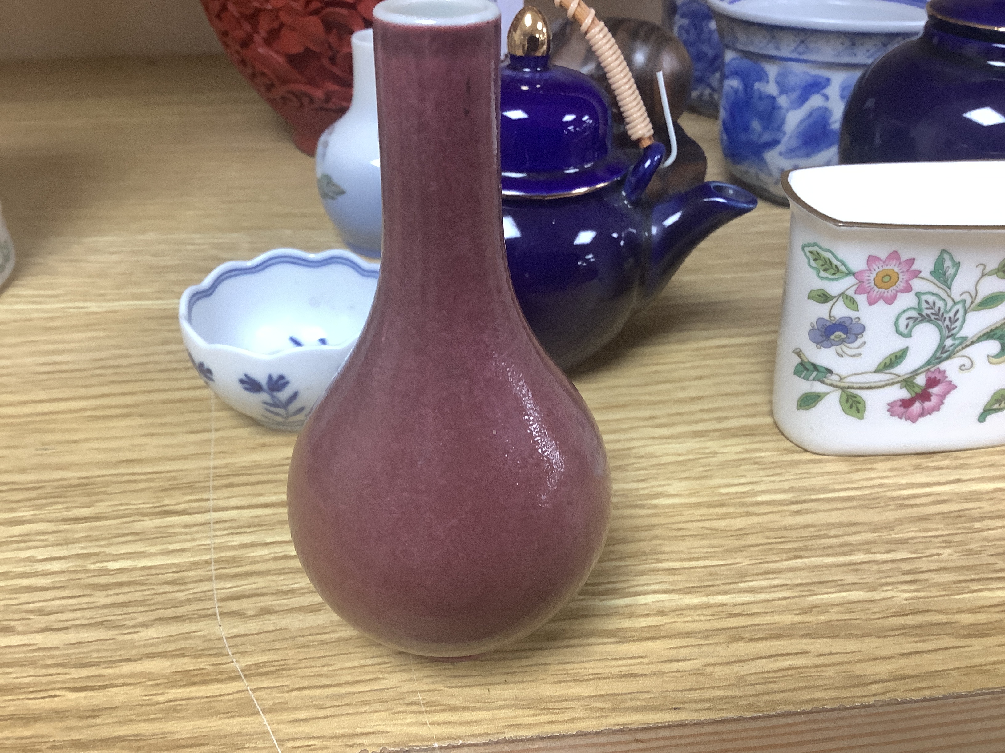 A Chinese cinnabar lacquer jar and cover, a Chinese copper red bottle vase, a carved wood figure, a Meissen miniature bowl and other ceramics, jar 15cm